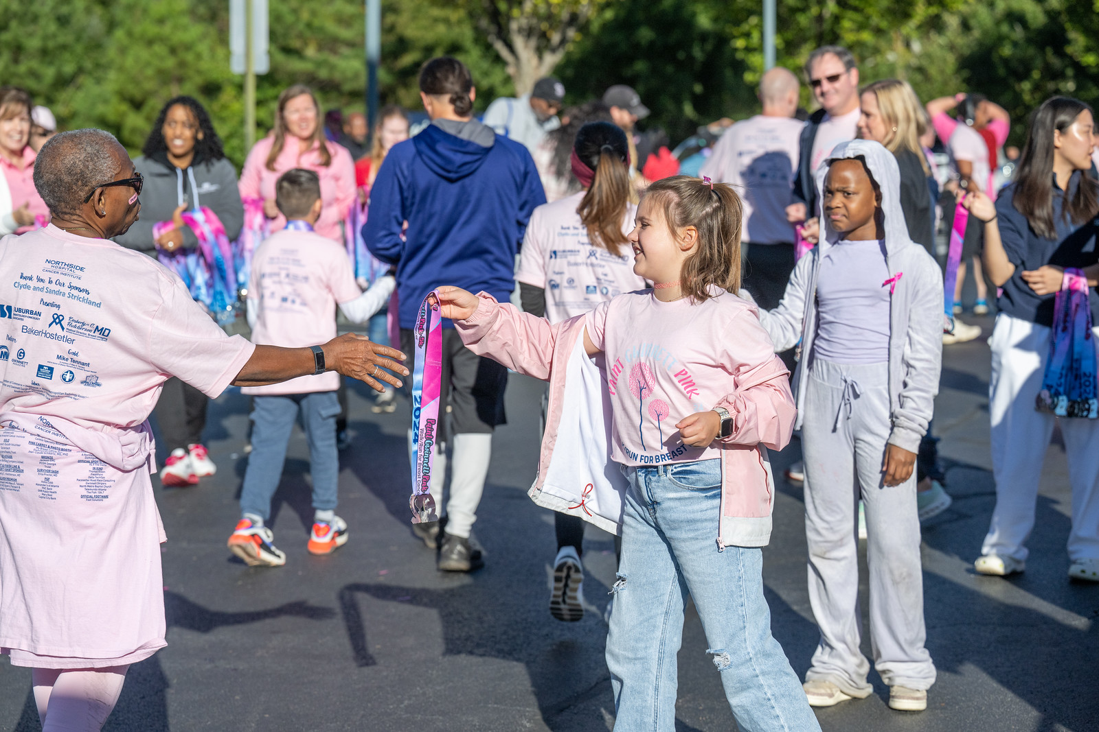 photo of girls handing out medals to runners